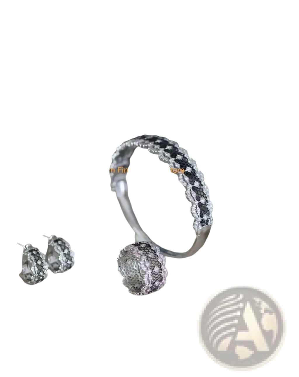 Silver teardrop tassel earrings gold vermeil displayed with silver lace bracelet featuring black and clear gemstones on marble tray
