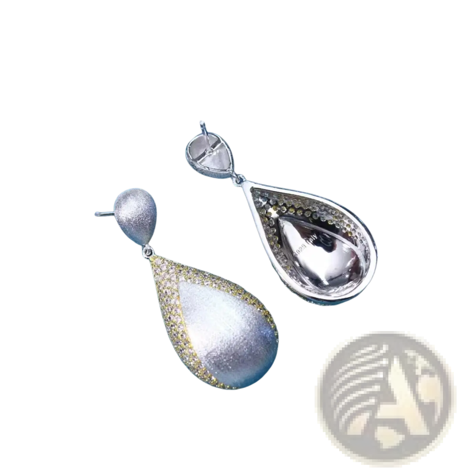 Silver teardrop tassel earrings with shimmering textured silver surface and delicate gold vermeil detailing