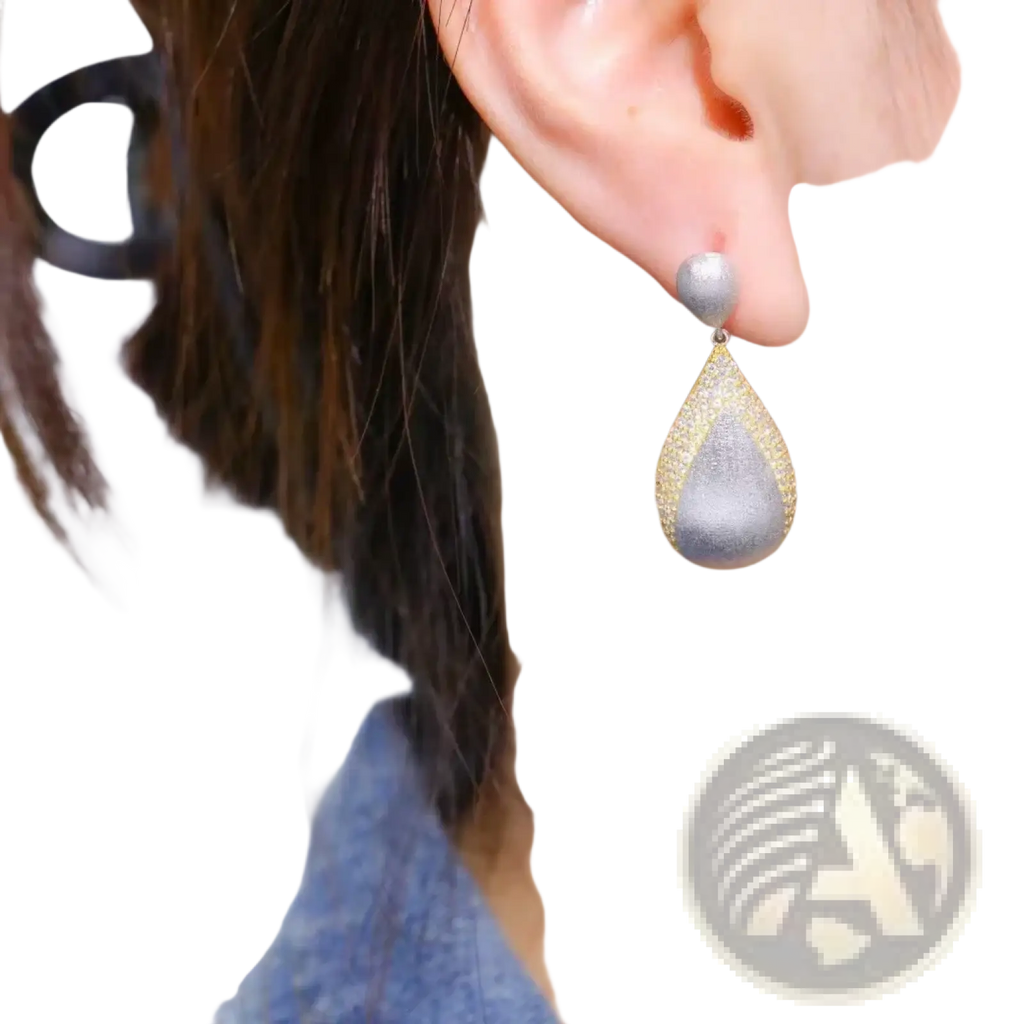 Silver teardrop tassel earring with textured glittering surface and gold vermeil边镶边 detailing
