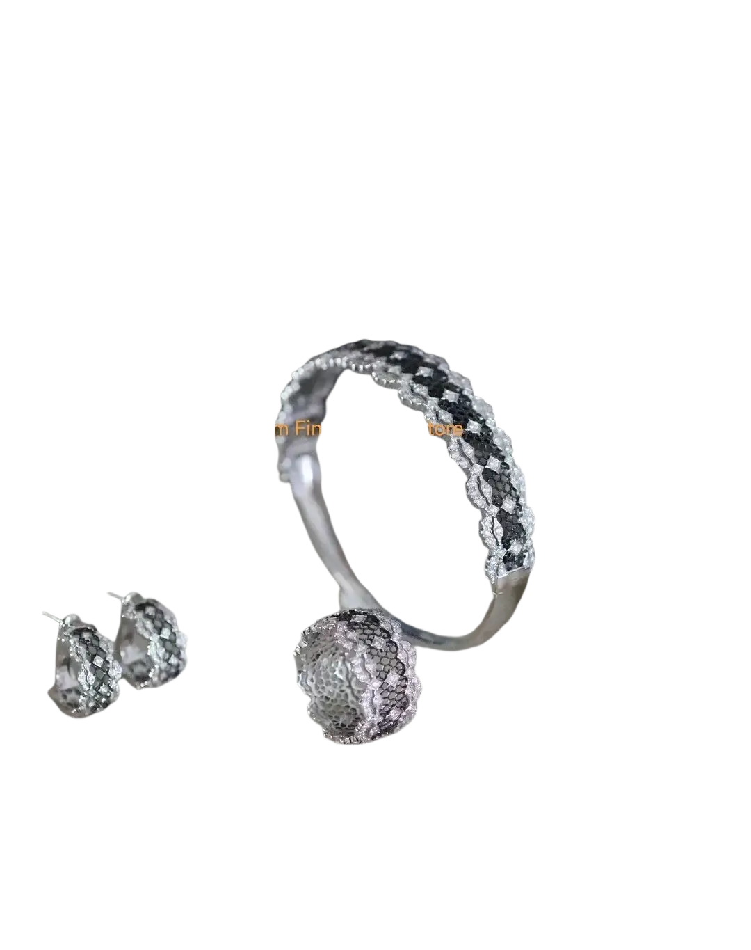 Silver teardrop tassel earrings gold vermeil displayed with silver lace bracelet featuring black and clear gemstones on marble tray