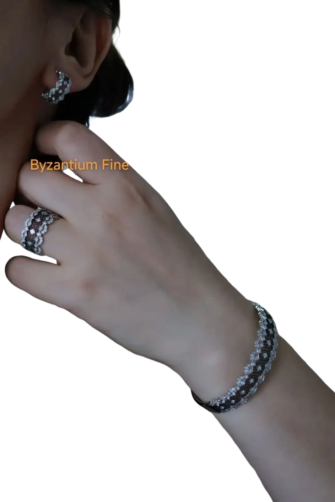 Silver-toned bracelet with textured pave-set diamond pattern complementing silver teardrop tassel earrings gold vermeil
