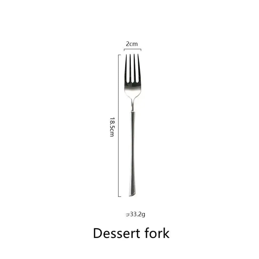 A sleek silver dessert fork with a slender handle and four tines from the polished silver western stainless steel cutlery set