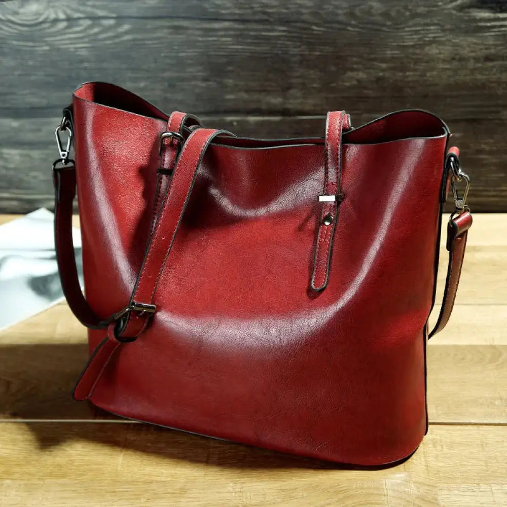Vintage oil wax leather tote and shoulder bag in rich red with structured soft shape and adjustable metallic straps