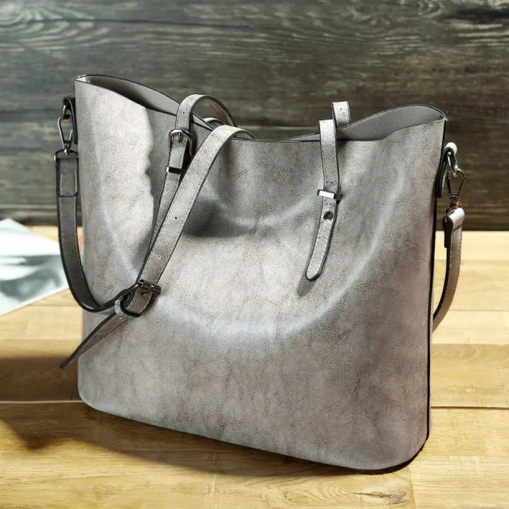 Gray textured faux leather vintage oil wax tote bag with adjustable shoulder strap and metal hardware
