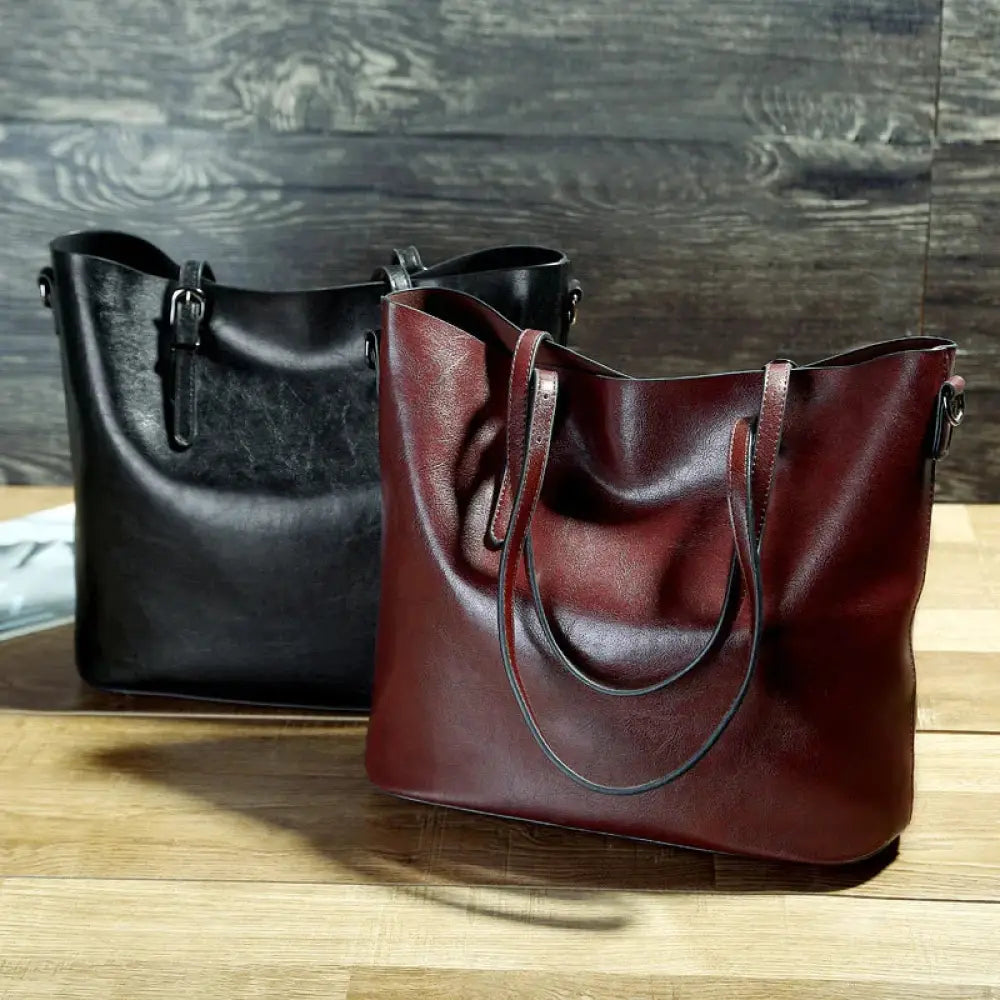 A rich burgundy vintage oil wax leather tote and shoulder bag with soft textured finish and matching handles