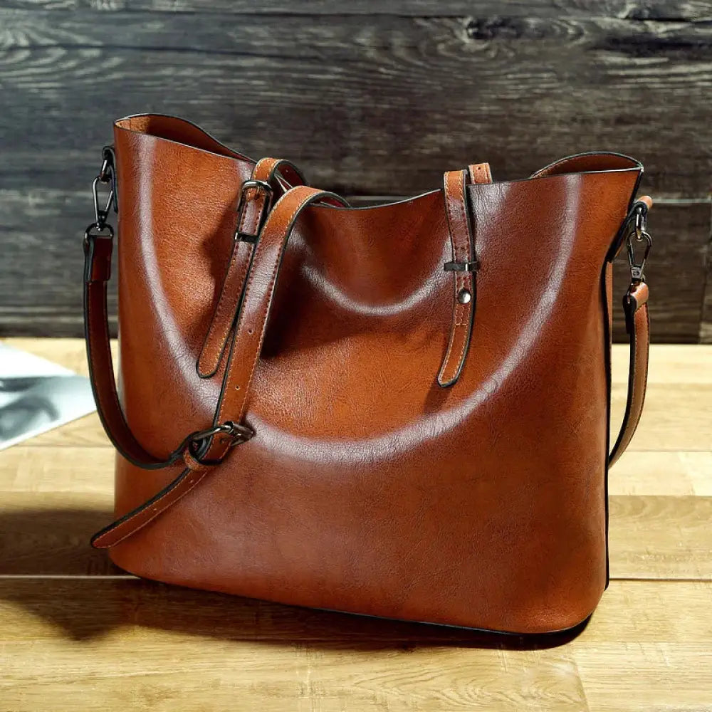 A rich brown vintage oil wax leather tote and shoulder bag with a soft distressed finish and adjustable straps