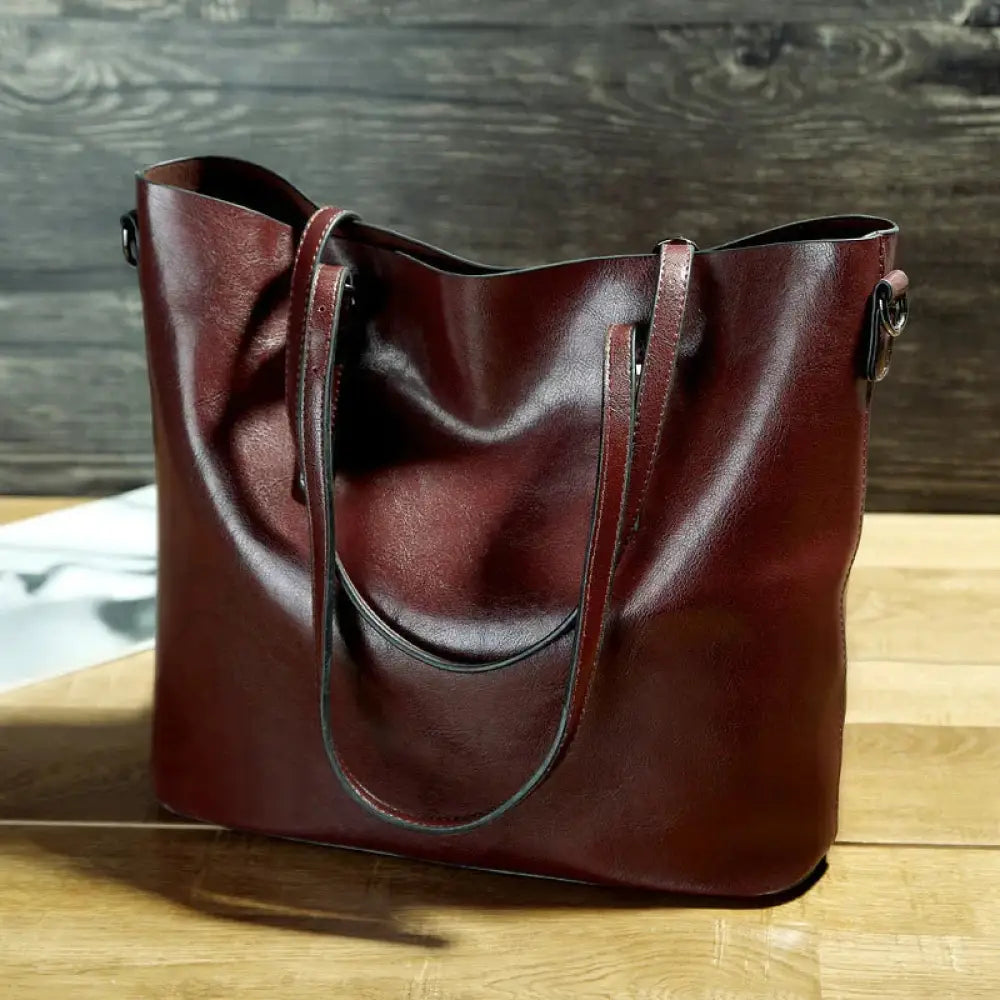 Vintage oil wax leather tote and shoulder bag in rich burgundy with sturdy handles and a sleek minimalist design