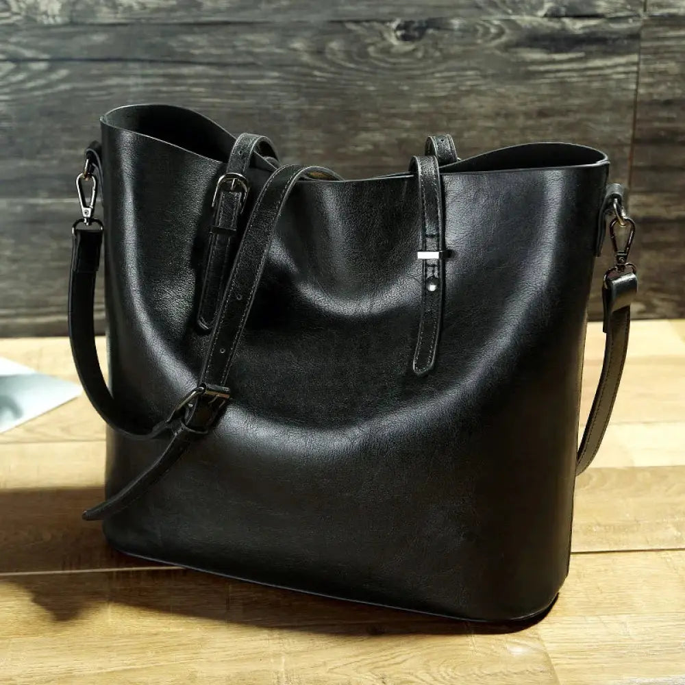 Black vintage oil wax leather tote and shoulder bag with adjustable shoulder strap and front buckle closure