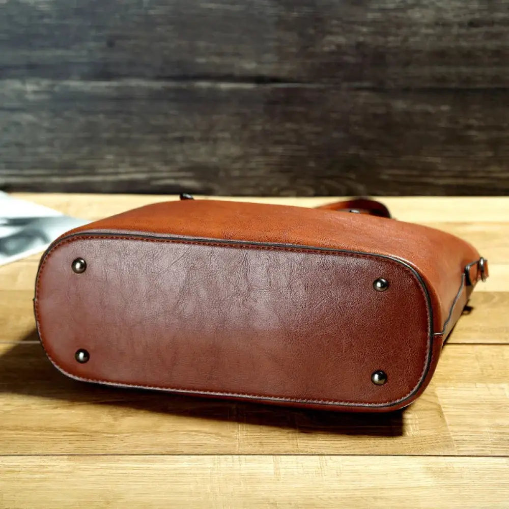 Vintage oil wax leather tote and shoulder bag in brown with rounded bottom and visible stitching detail