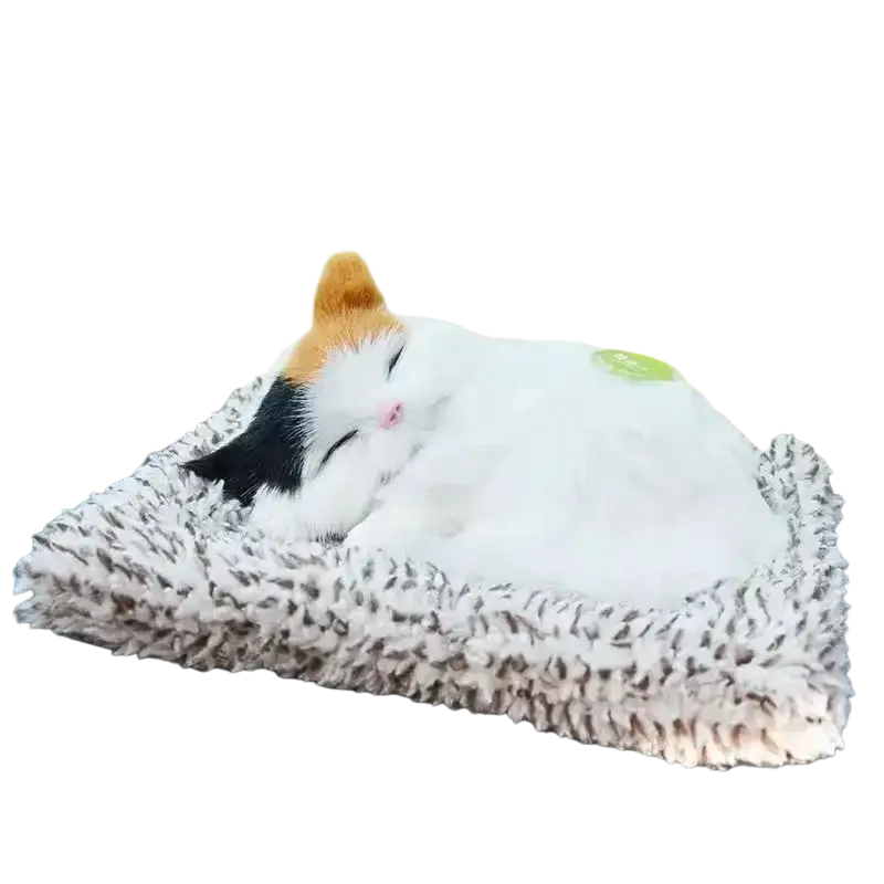 A plush calico sleeping cat toy with sound features white black and orange fur nestled in a soft gray fuzzy bed
