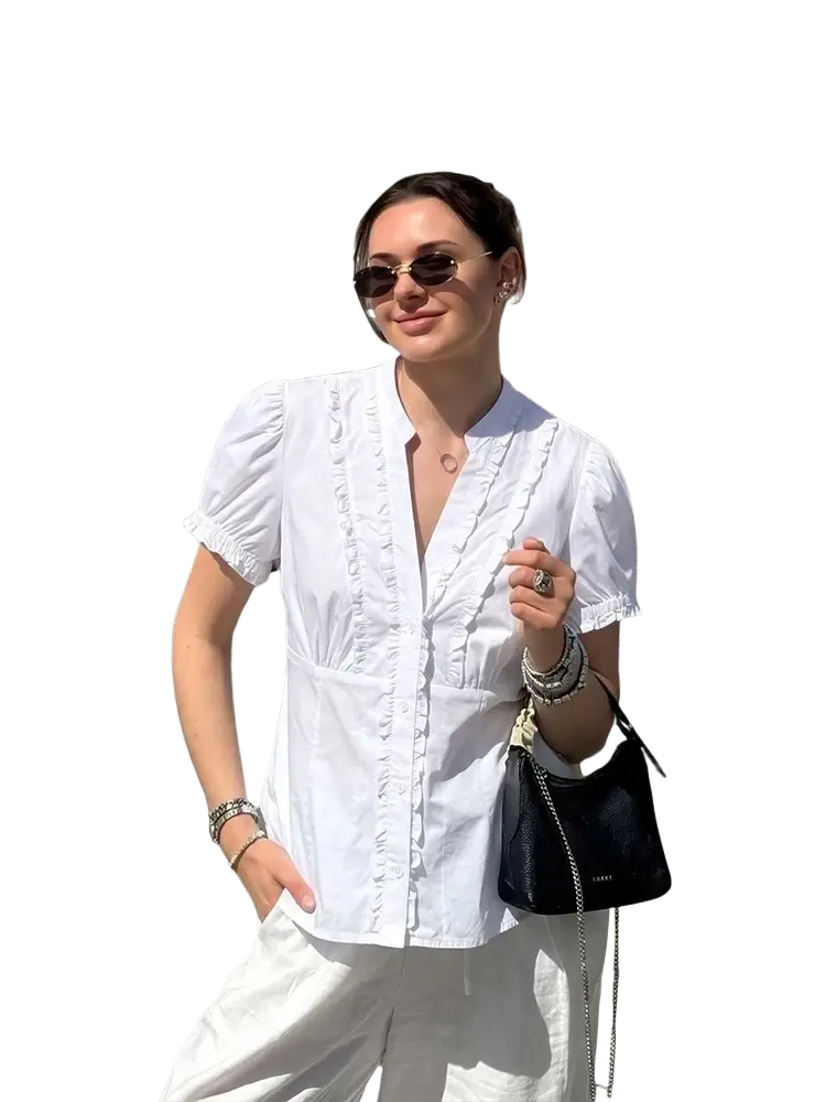 Black leather crossbody bag with silver chain strap paired with single breasted striped ruffled blouse