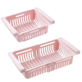 Pink plastic sink drain rack with slotted sides handle made of food-grade polypropylene adjustable kitchen shelf