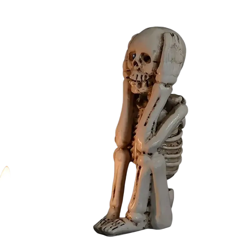 A white glossy resin skeleton decoration with distressed texture and detailed bones for art deco tabletop mounting