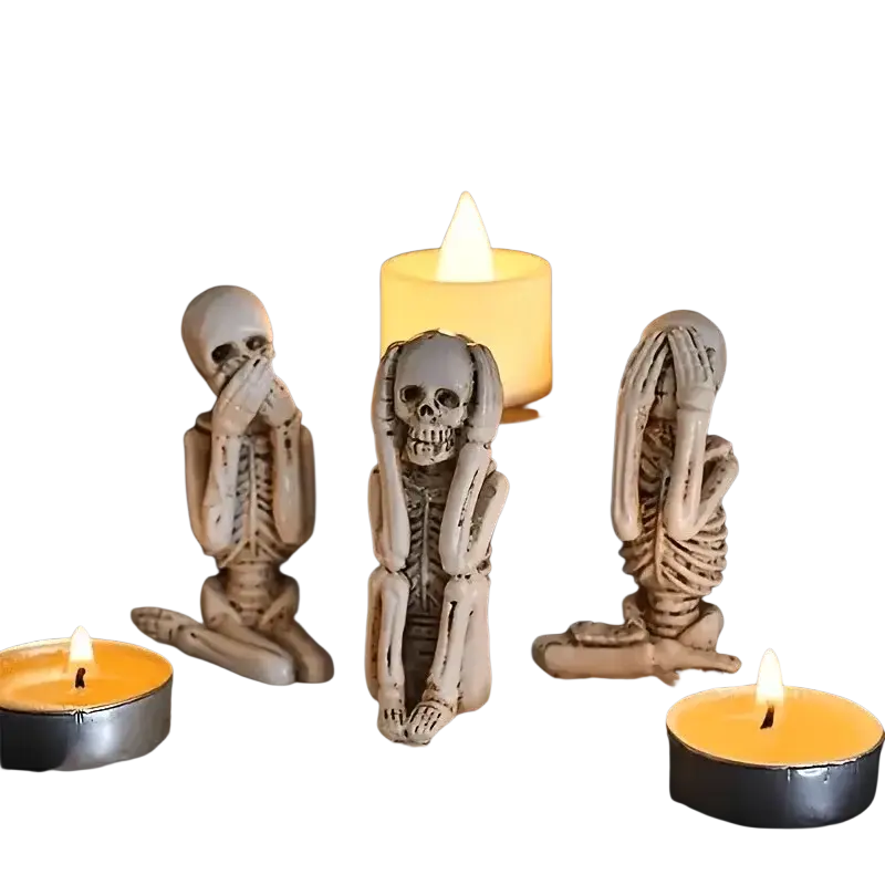 Three white resin skeleton decoration figurines in art deco style posed on parchment for tabletop mounting
