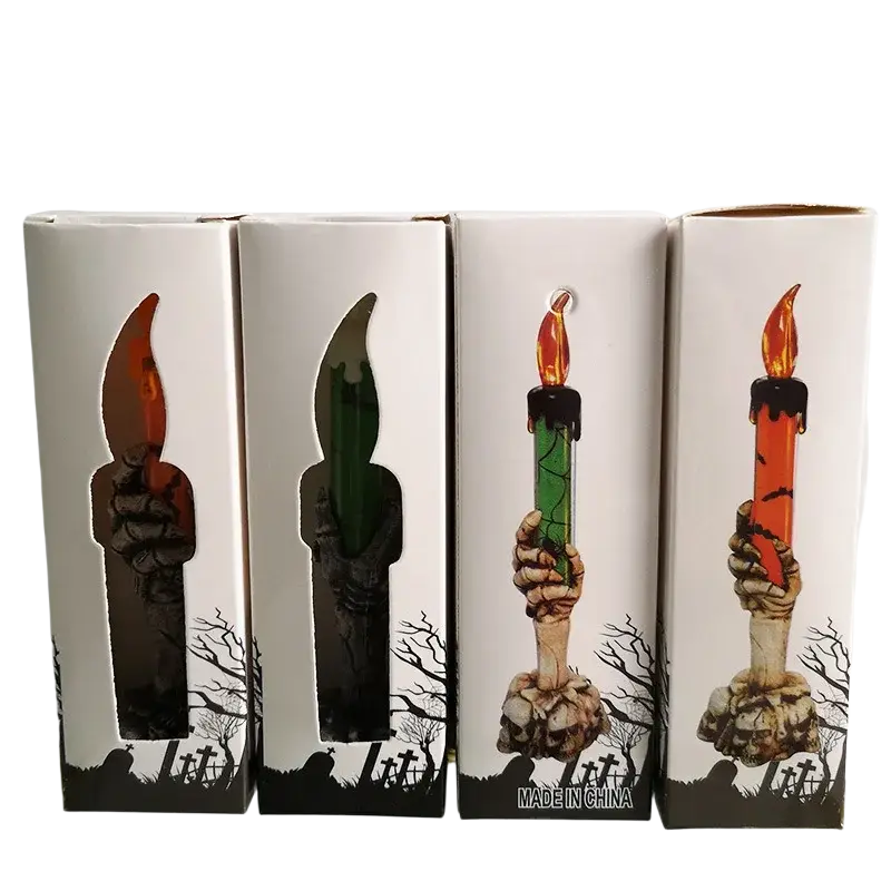 Skeleton hand led candle with glowing orange and green flames on skull base for happy halloween party decoration