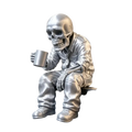 Silver skeleton office worker coffee figurine dressed in suit holding matching metallic mug in hand