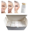 A clear glass vial with a gold cap containing white collagen essence for skin care moisturizing
