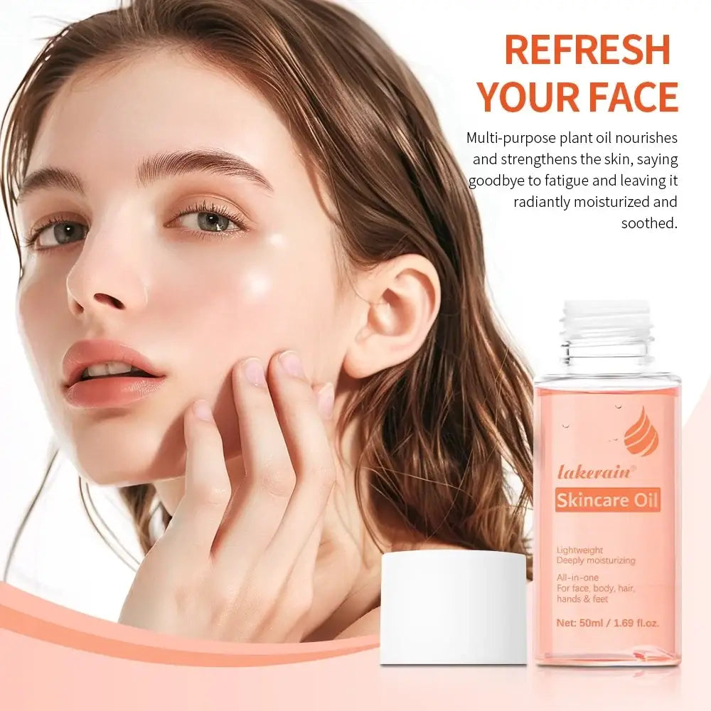A clear glass bottle with white cap containing pinkish-orange lakerain skin care oil for moisturizing face body hair hands and feet