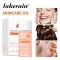 Lakerain skin care oil moisturizing hydrating body treatment in clear glass bottle with white cap and light pink liquid
