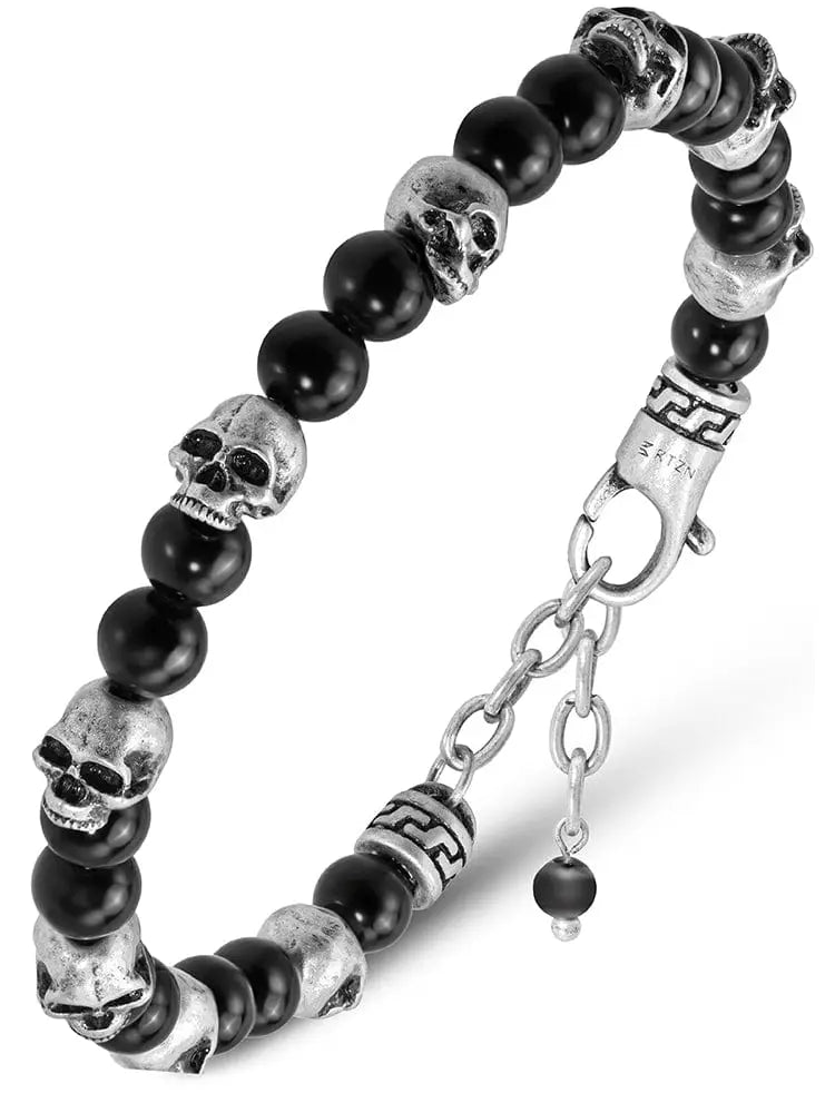 Black obsidian and silver skull beaded bracelet featuring silver skulls black beads and a chain clasp for secure wear