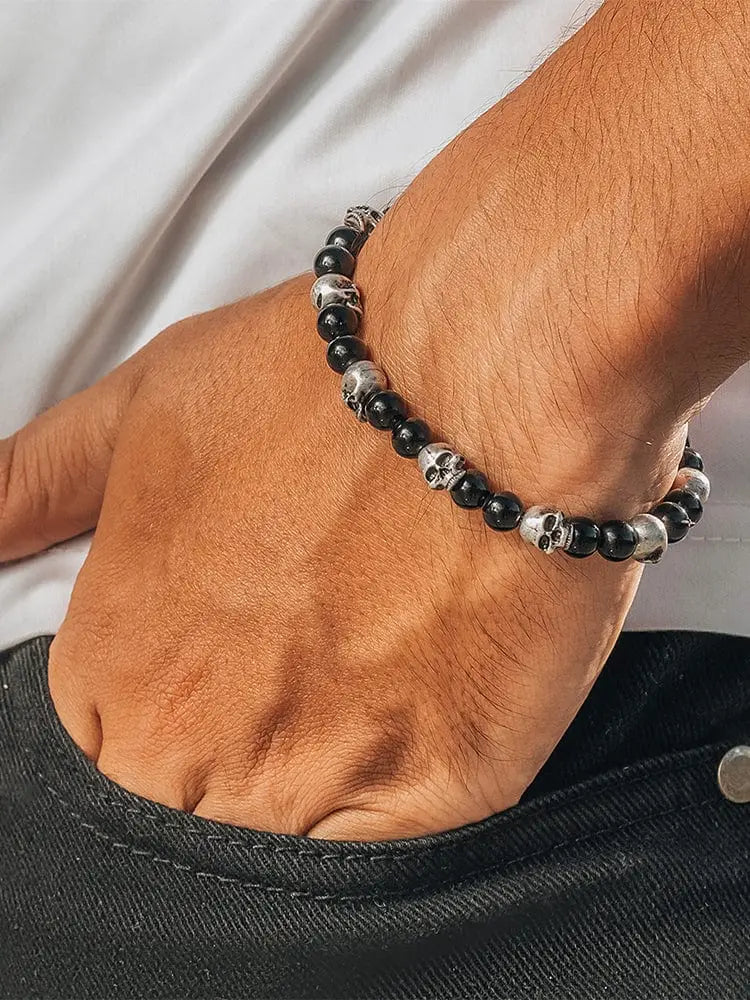 Black obsidian and silver skull beaded bracelet with alternating polished black and silver beads in a sleek design