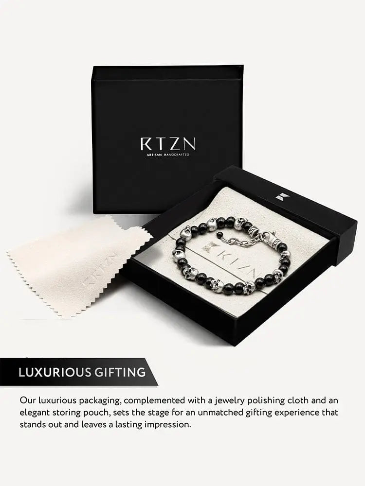 Black obsidian and silver skull beaded bracelet displayed in a sleek rtzn gift box for stylish gifting
