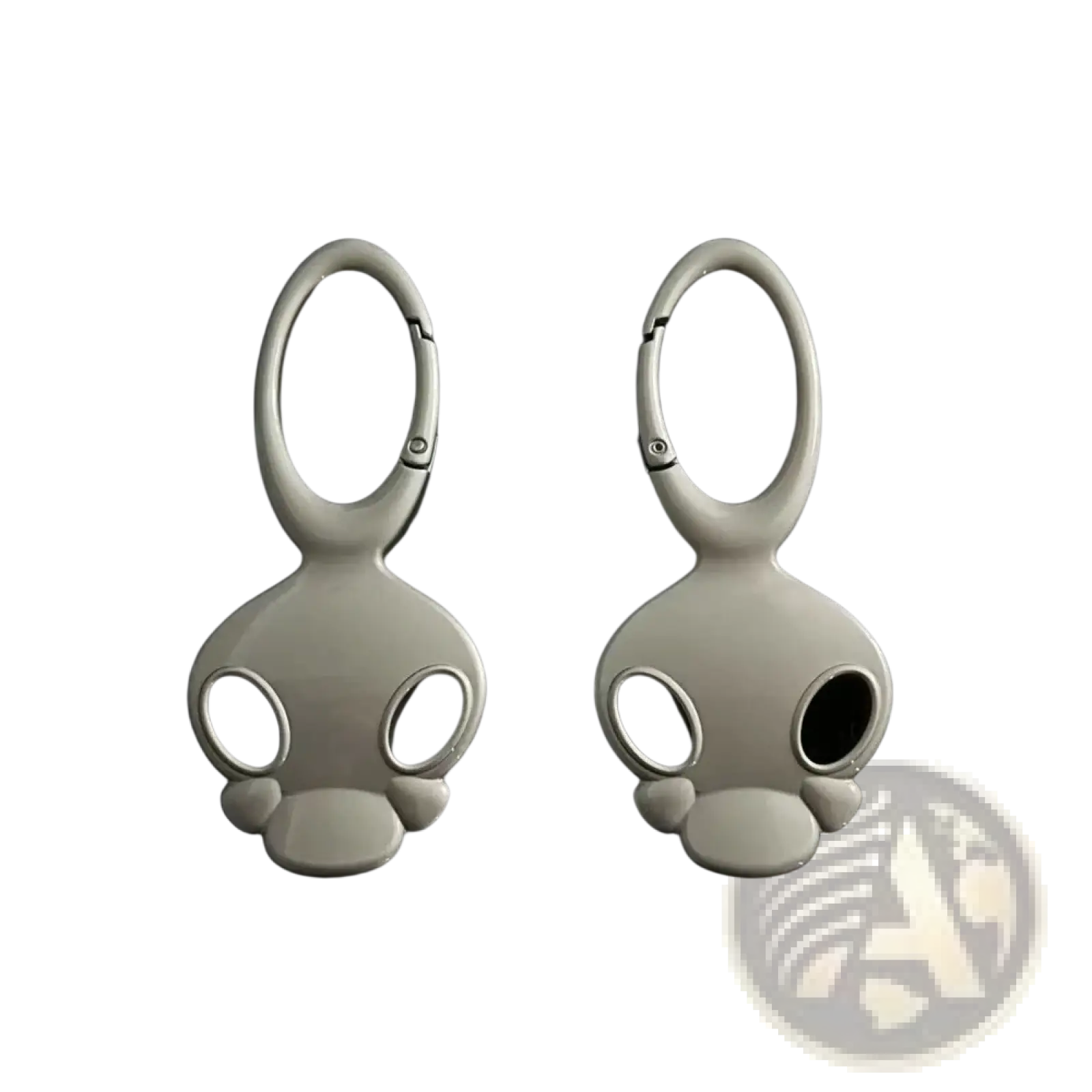 A pair of sleek matte white skull metal car keychains with black eye cutouts and smooth metallic loops for bags and keys