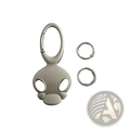 Silver-colored glossy metal skull keychain with stylized cartoon head design for car keys or bag charm