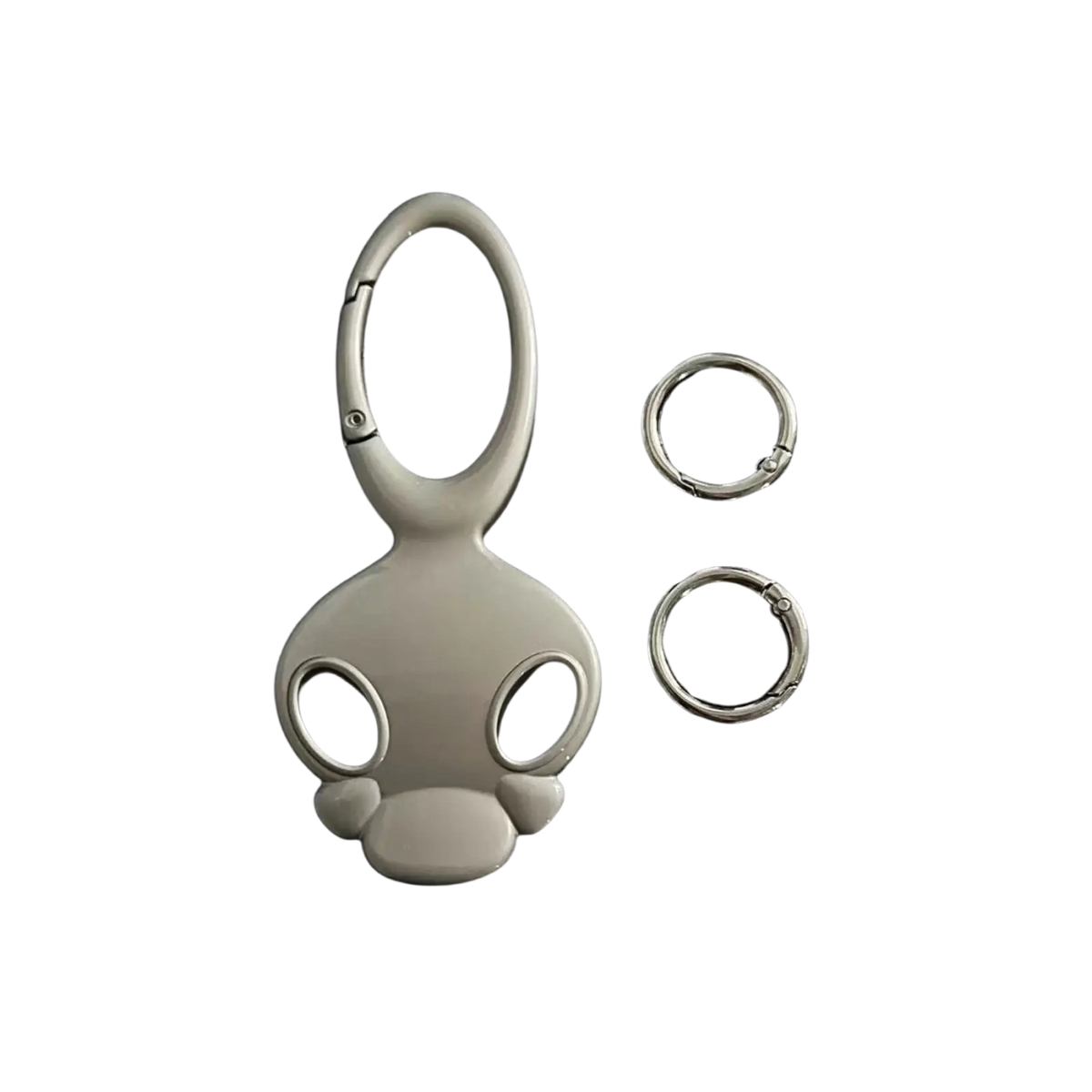 Silver-colored glossy metal skull keychain with stylized cartoon head design for car keys or bag charm