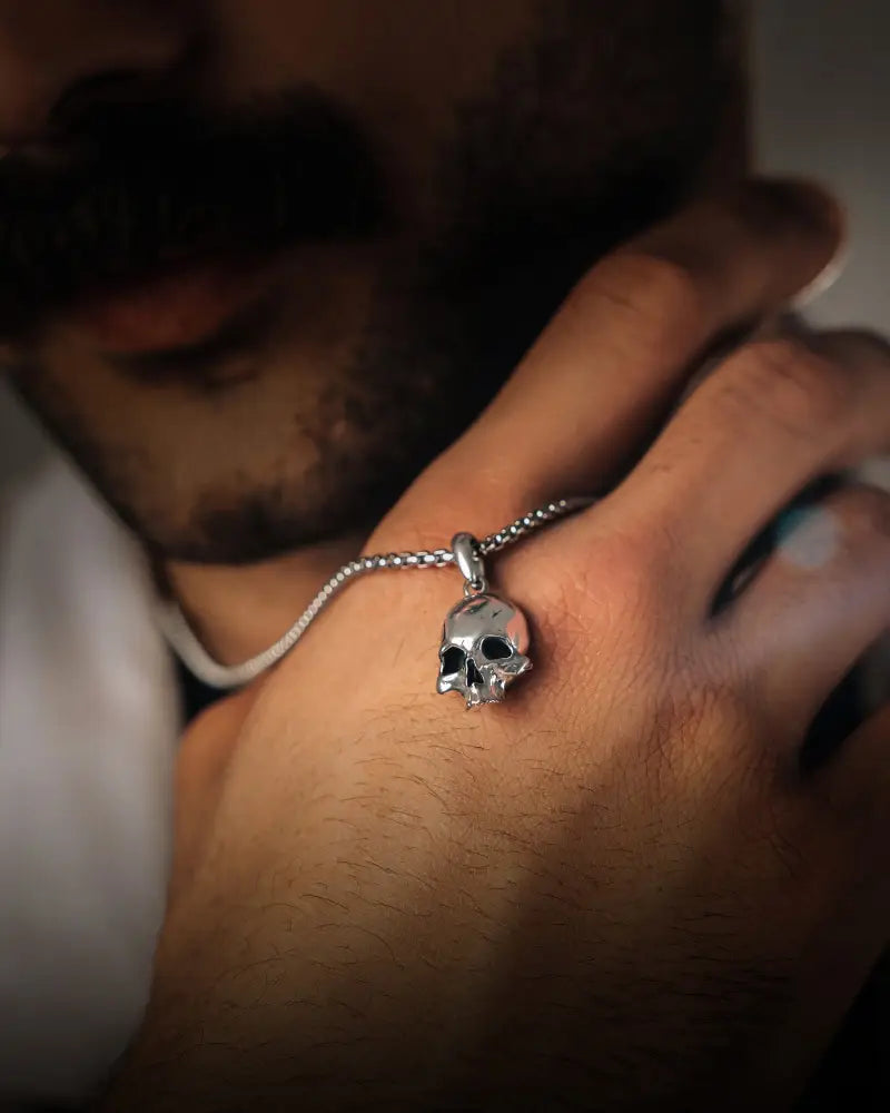 Silver gothic skull pendant made of stainless steel worn as a bracelet on a fine box chain