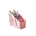 Slanted woven plastic desk organizer in pink with a lattice design and multiple compartments for pens and supplies