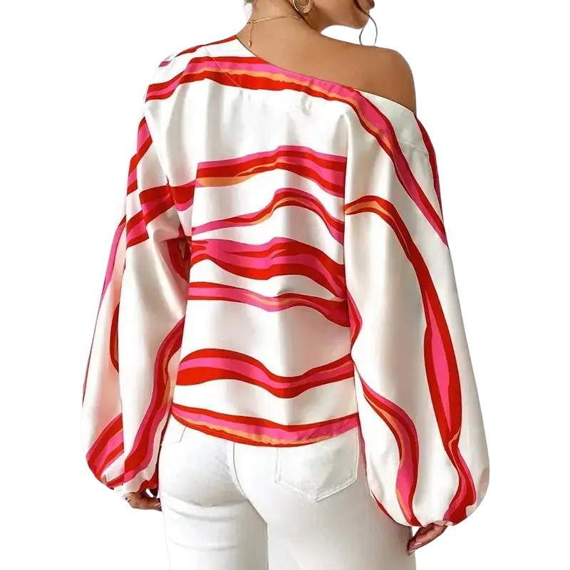 A woman wears a white satin slash neck off shoulder blouse with bold pink and red wavy stripes and sleeve style details