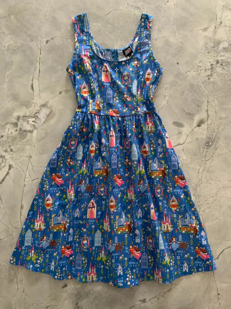 Sleeping Beauty cotton fit and flare dress in blue sleeveless fabric with Disney princesses castles and birds pattern