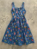 Sleeping Beauty cotton fit and flare dress in blue sleeveless fabric with Disney princesses castles and birds pattern