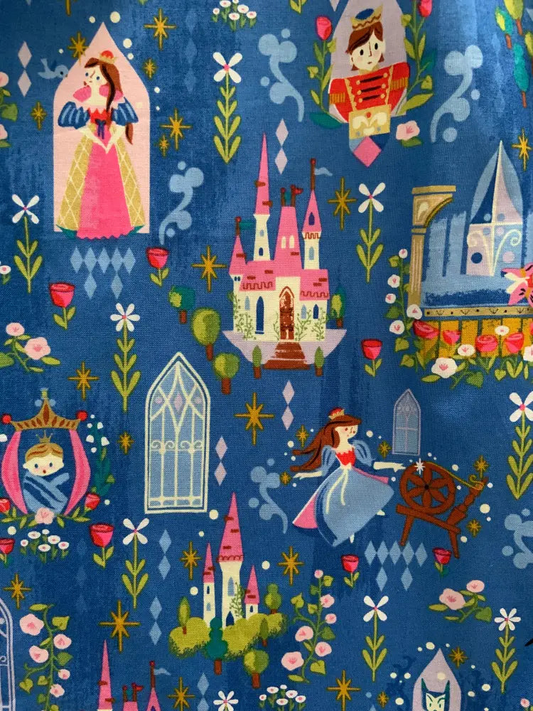Blue cotton sleeping beauty fit and flare dress with pockets featuring whimsical castles and fairy tale characters pattern