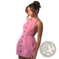 A pink sleeveless backless mini dress featuring gold floral buttons down the front