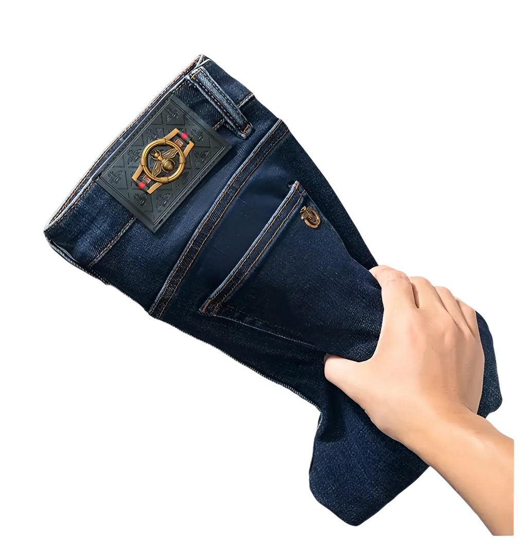 Slim fit dark blue denim jeans for men showing the back side with a prominent gold bee emblem on the pocket