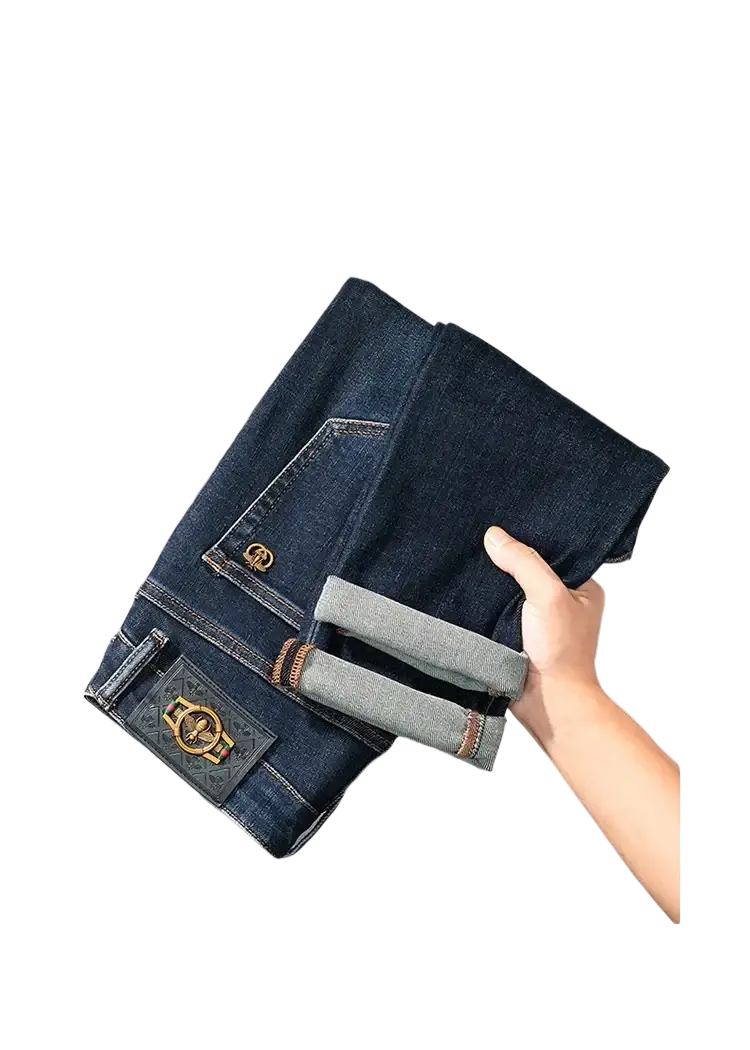 Slim fit dark blue denim jeans for men showing back side with gold toned belt loop and decorative patch on pocket