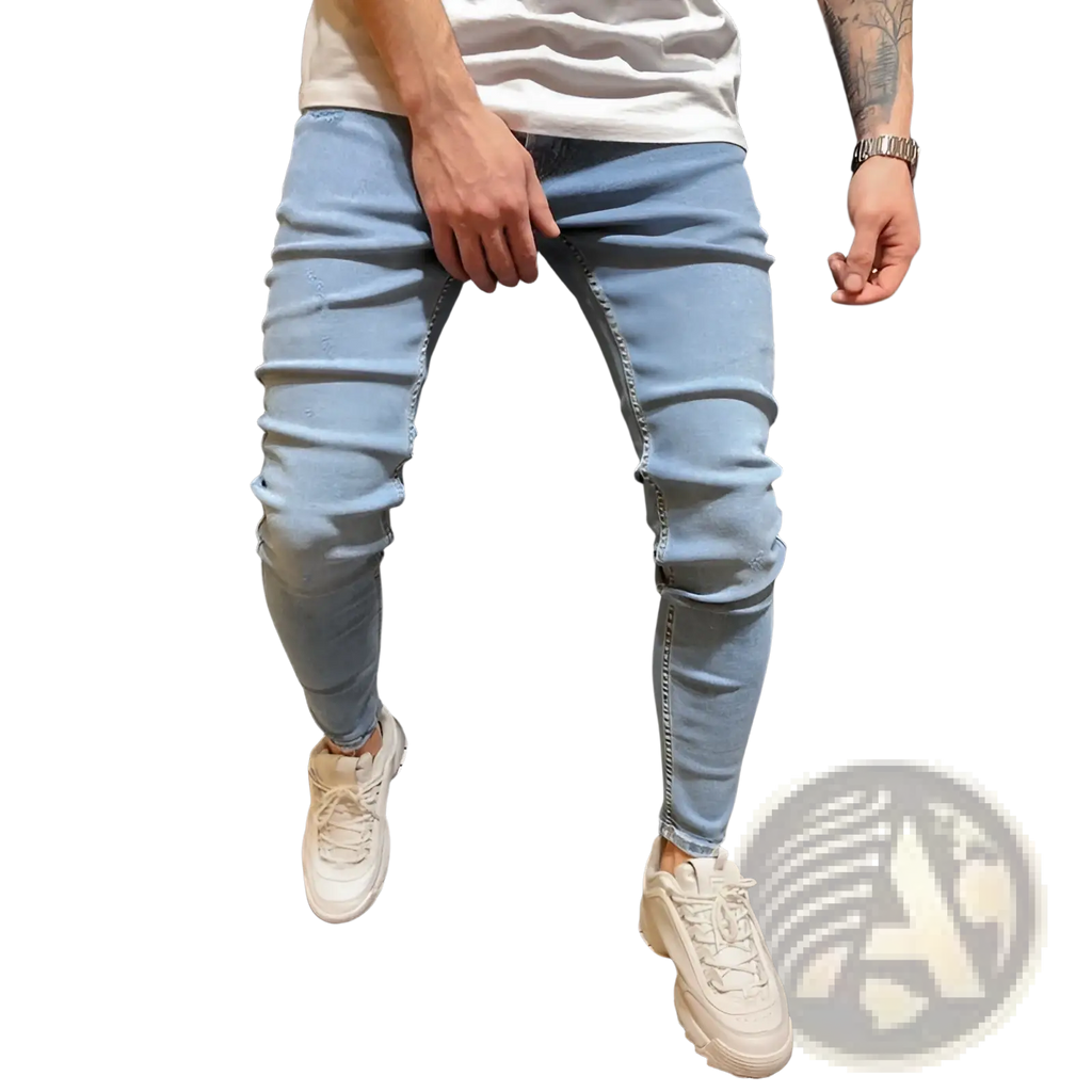 Slim fit light wash distressed denim jeans in light-wash denim with subtle distressing and a slim-fit cut