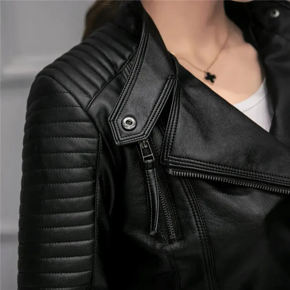 Women’s slim fit black faux leather motorcycle jacket with quilted shoulder panels and silver snap button closure