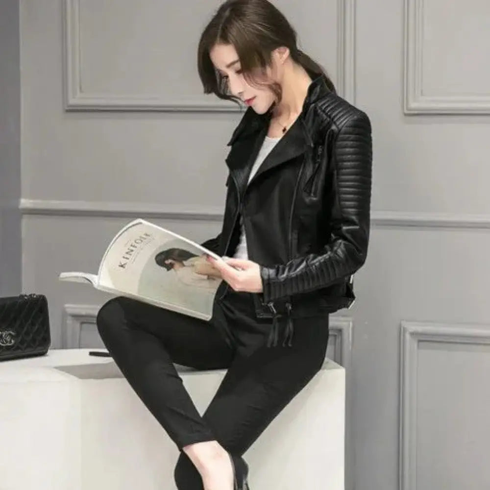 Black slim fit quilted faux leather motorcycle jacket with ribbed sleeves and front zipper detail for women