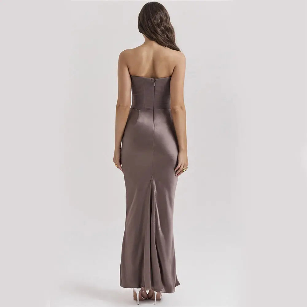 A sleek taupe satin strapless backless mermaid evening gown with a fitted corset bodice and flowing skirt