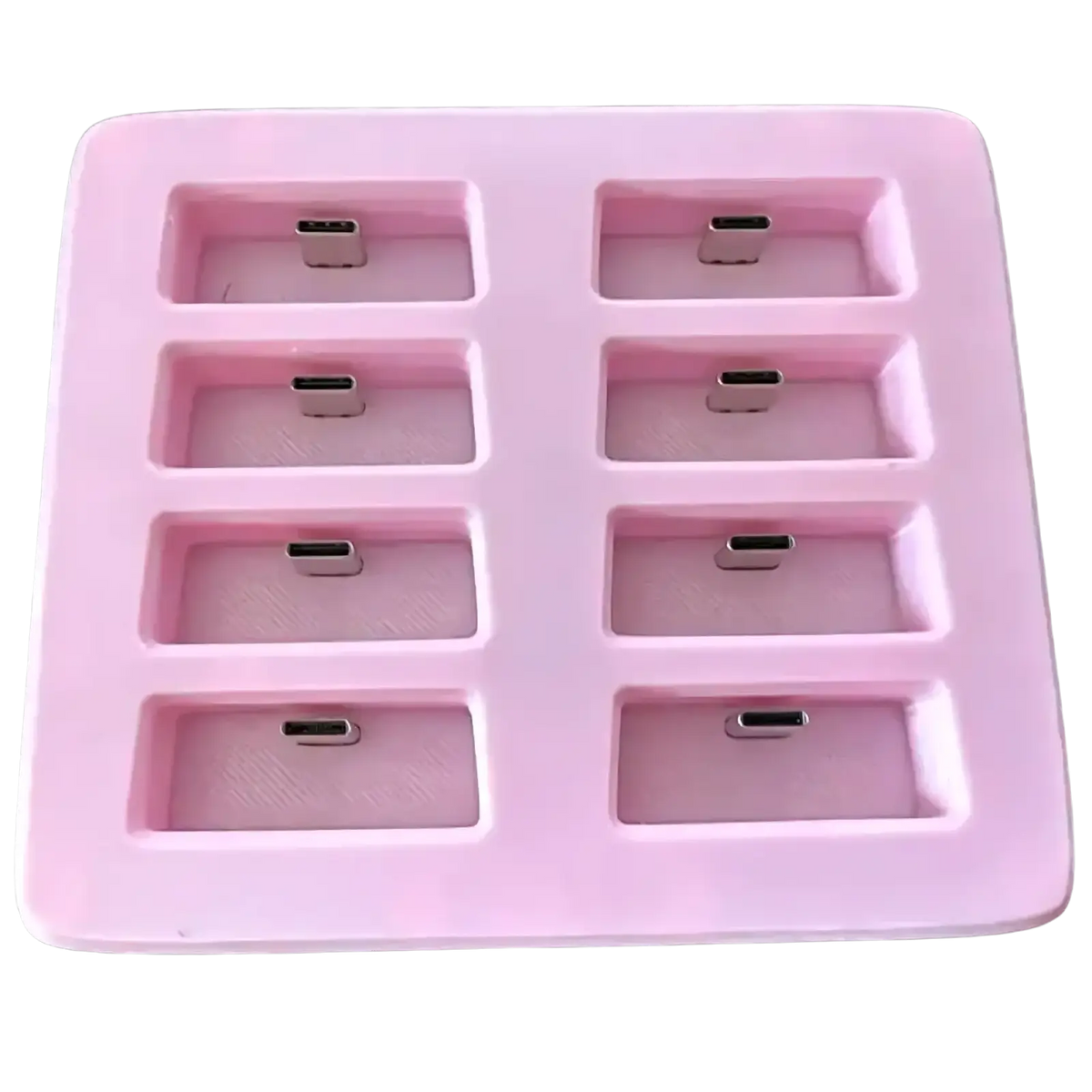 Pink silicone slimevr charging dock with eight rectangular compartments holding silver usb-c connectors