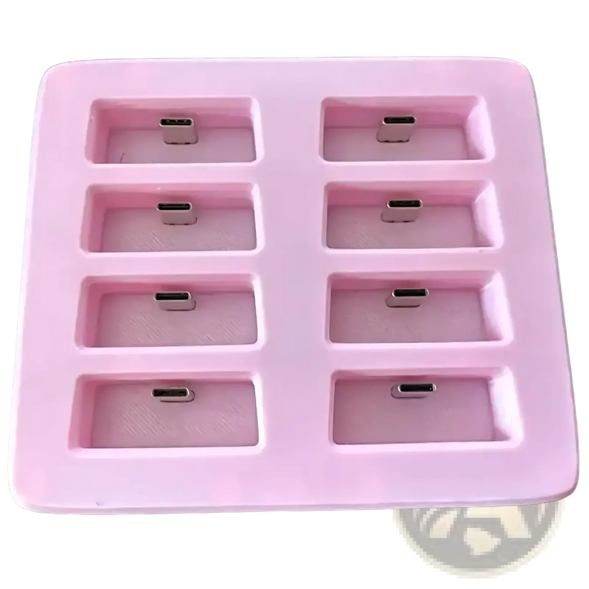 Pink silicone slimevr charging dock with eight rectangular compartments holding silver usb-c connectors