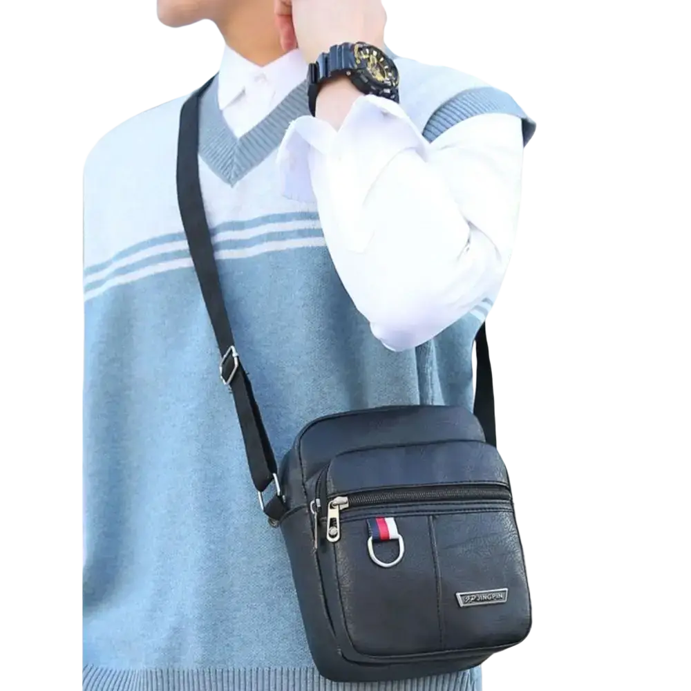 Black leather sling bag messenger with red white and blue striped zipper pull for casual use