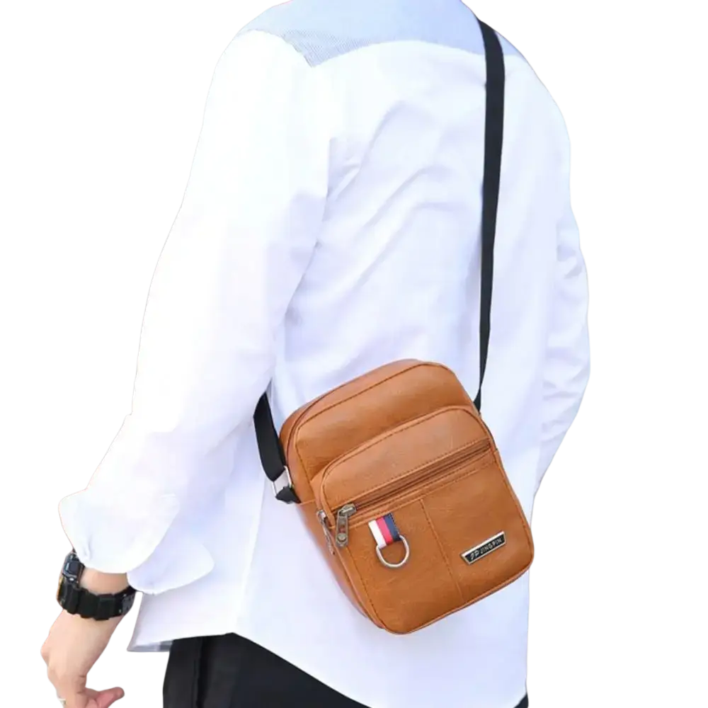 Tan leather sling bag messenger with black strap and red white blue flag-style zipper pull for casual use