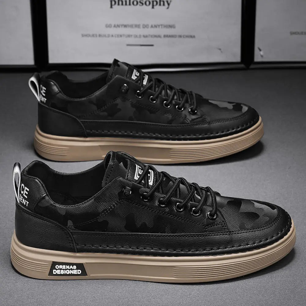 Back view of men’s casual suede and leather slip-on sneakers in black camouflage with tan sole and white branding on heel