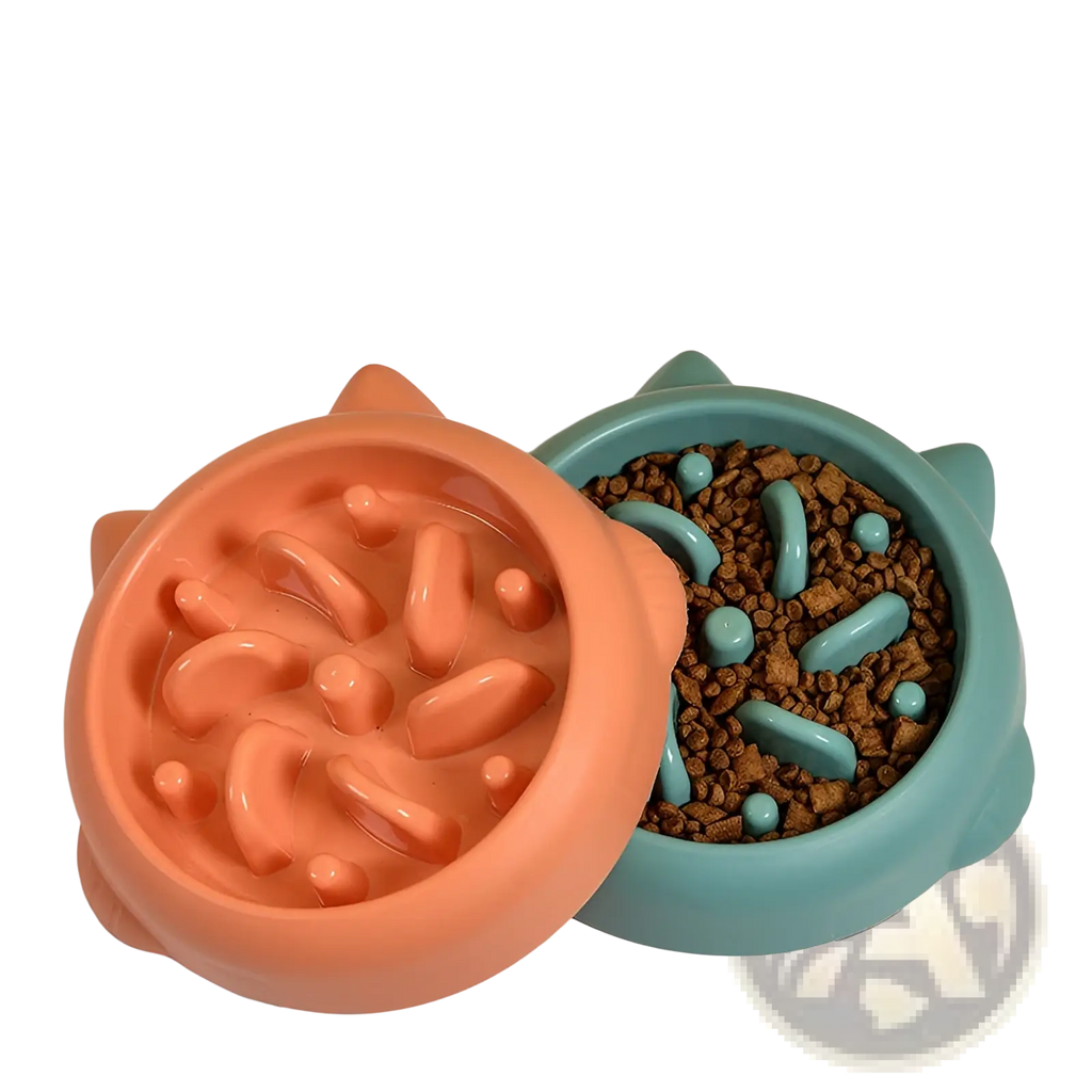 Two cat-shaped slow feeder dog bowls in coral and teal with molded silicone textures to prevent gulping