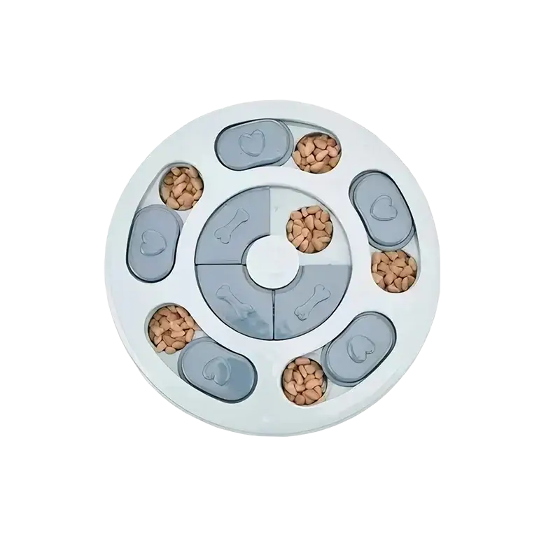 White circular slow feeder interactive educational dog toy with gray heart and bone shaped removable lids holding kibble