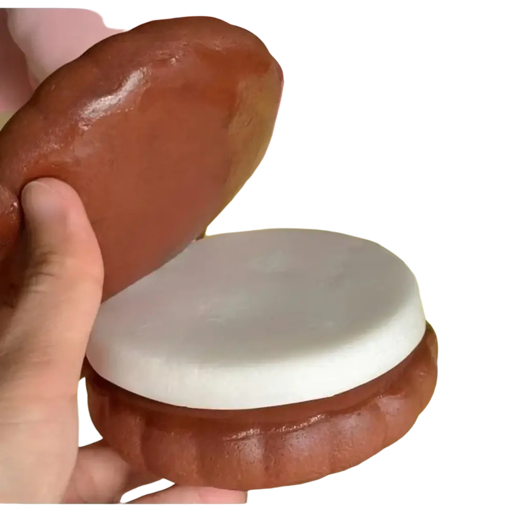 A slow rising big cookie squishy toy in glossy brown and white with a realistic cake texture and soft, squishy feel